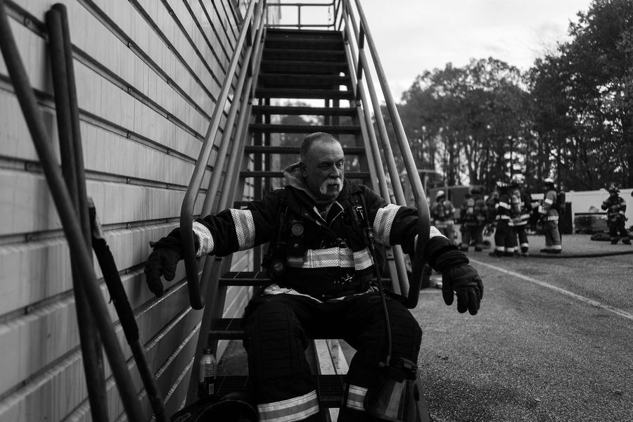 A firefighter on an exterior stair during training